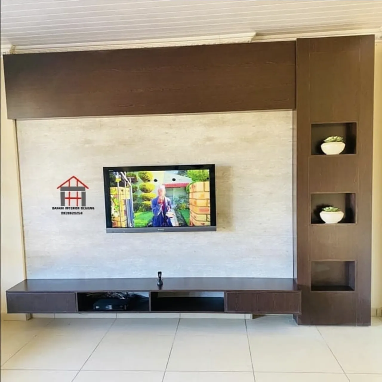 The wenge TV stand front on: a long low unit, a stone panel and three lit niches.