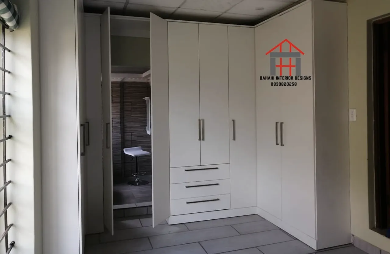 The same bedroom cupboard from the corner, with one door open on the shoe section.